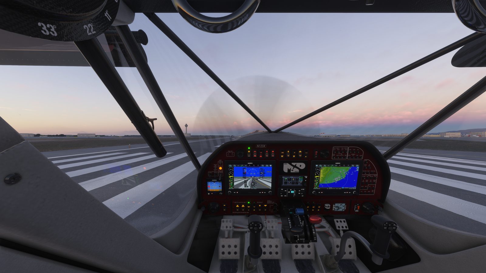 Twin glass PFD and MFD mounted in the Patey Draco cockpit at dusk